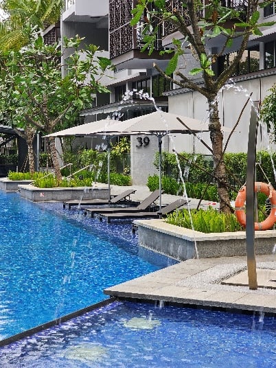 Condominium pool deck with sun loungers re-slung by Hong Heng, Singapore.